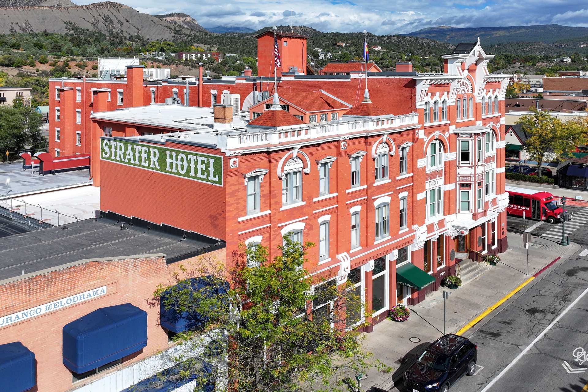 Aerial view of the Strater Hotel and the surrounding downtown blocks of Durango, with hills in the distance
