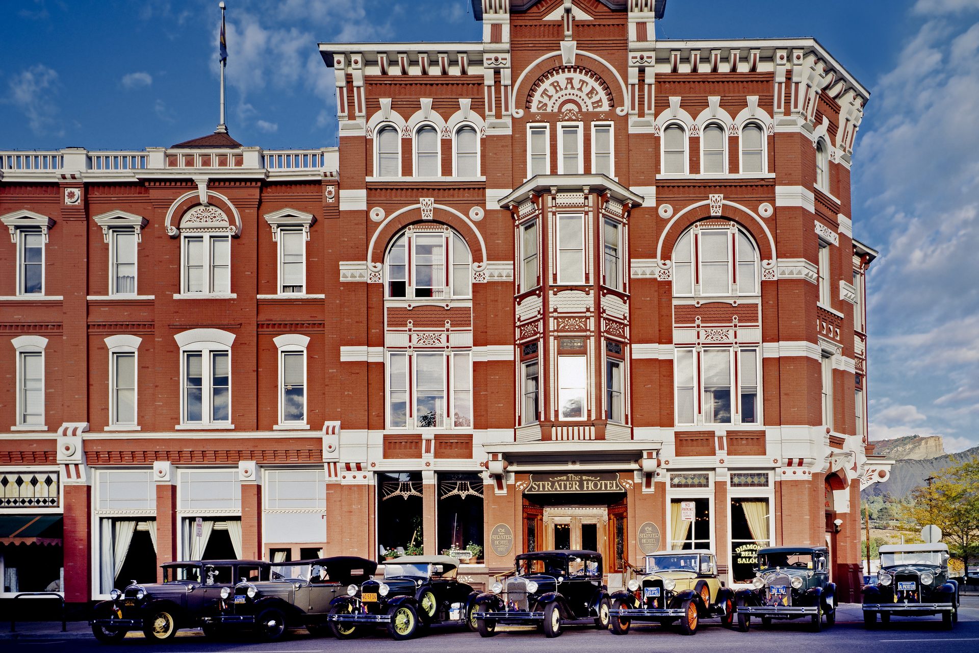 Vintage automobiles parked in front of the red-brick Strater Hotel, opened in 1888 on Main Avenue in Durango