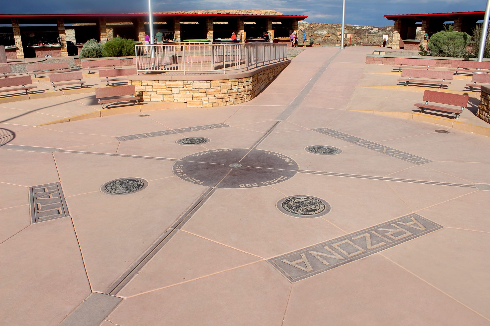 Four Corners Monument plaza with the circular marker at its center and Arizona lettering set into the paving