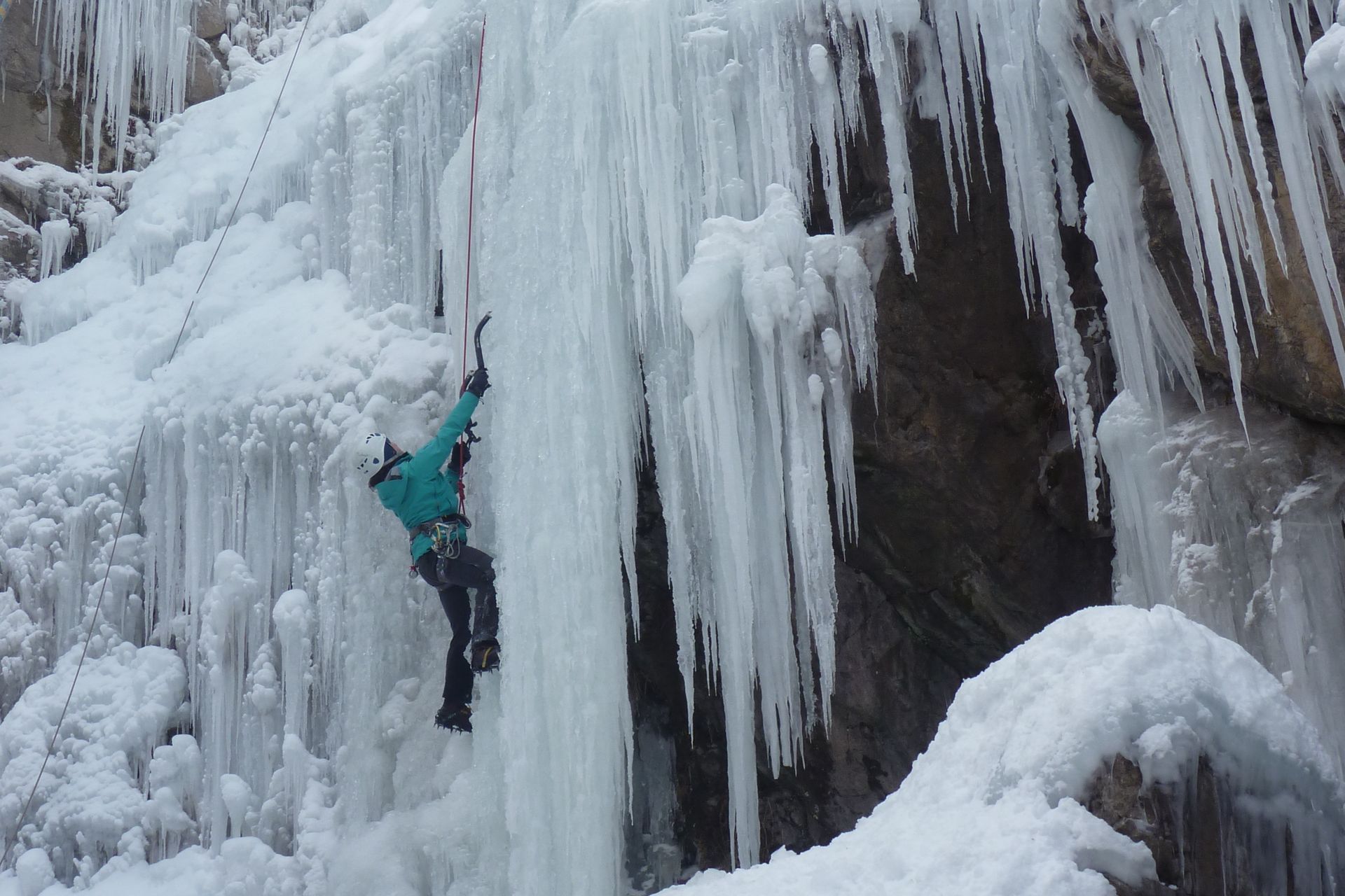 Ice climber on a top-rope route up a curtain of icicles in the Scottish Gullies section of Ouray Ice Park