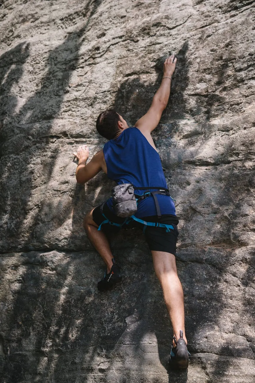 A climber bouldering on a sandstone rock face near Durango, Colorado, no rope, with a chalk bag